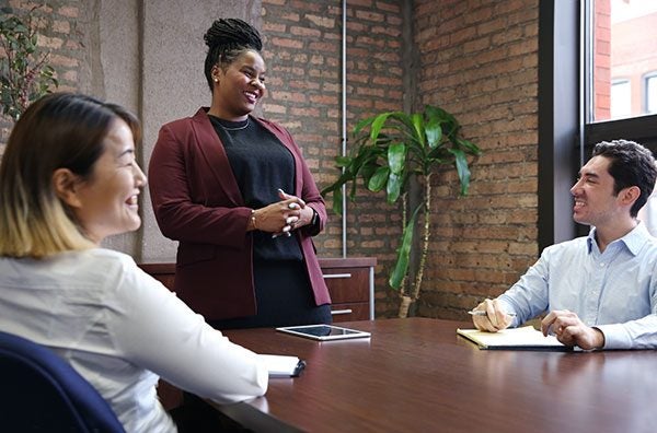 UIC Business students around a conference table