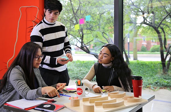 Student work around a table