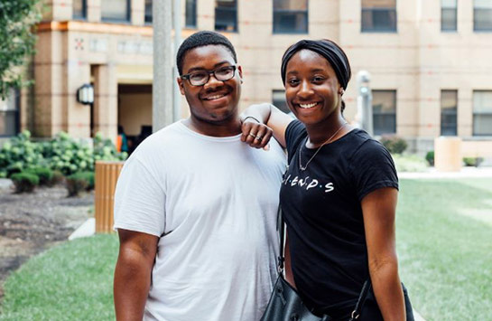 Two UIC students standing outside and smiling