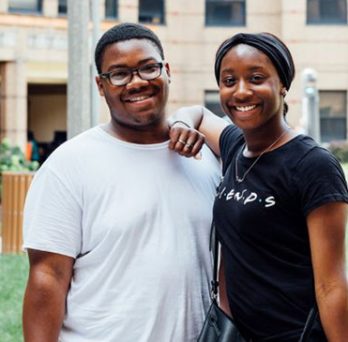 Two UIC students standing outside and smiling 