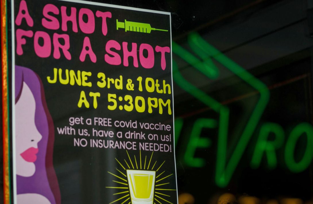 In Portland, Ore., a bar sign offering customers free alcohol if they receive a COVID-19 vaccine
