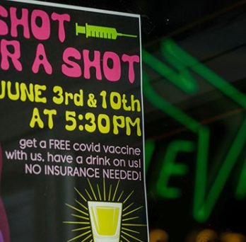 In Portland, Ore., a bar sign offering customers free alcohol if they receive a COVID-19 vaccine 