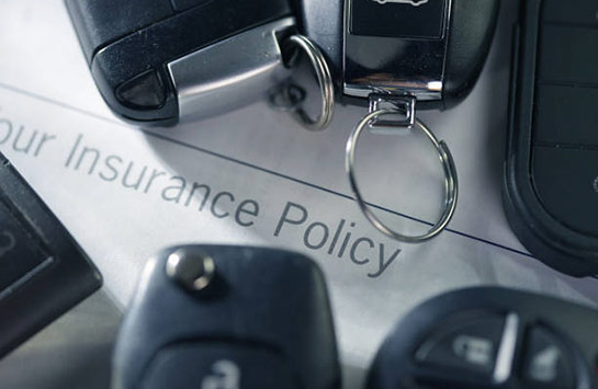 A car insurance document and car keys
