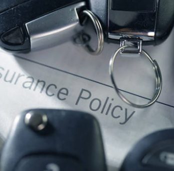 A car insurance document and car keys 