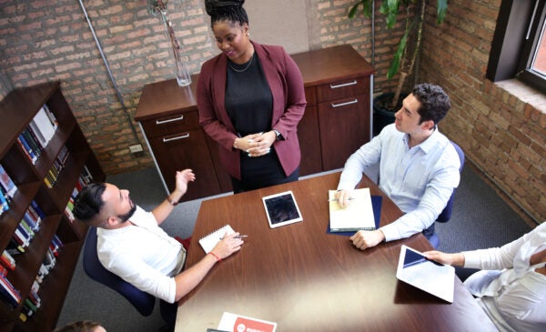 3 students at a conference table