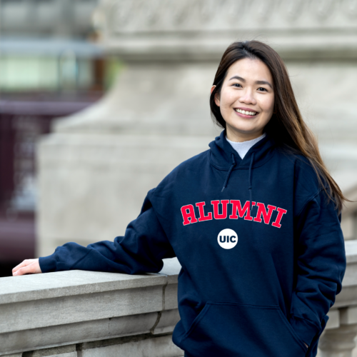 Former student wearing a UIC Alumni hooded sweatshirt