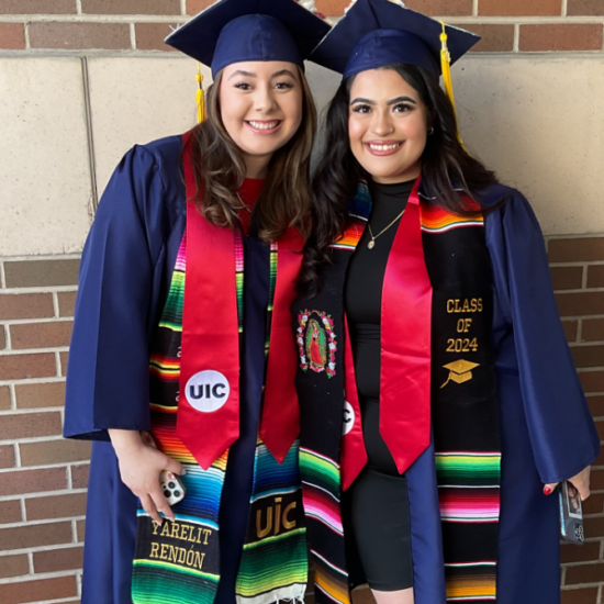 Two graduates in their caps and gowns