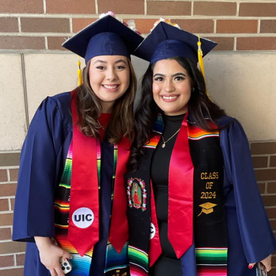 Two graduates in their caps and gowns