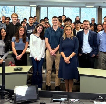 UIC Business Finance Department faculty with students in a classroom.
                  